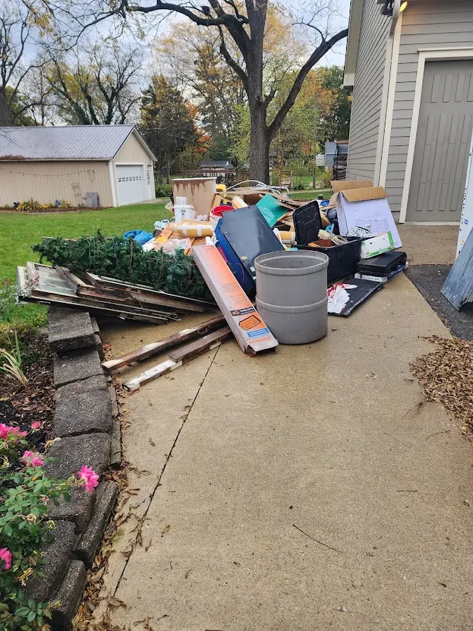 Dumpster being loaded with debris for 12 Yard Dumpster Rental in Hebbronville